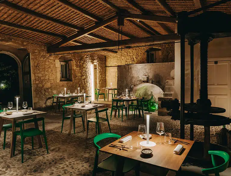 The Dodici Zappe restaurant with candlelit tables under a beamed ceiling